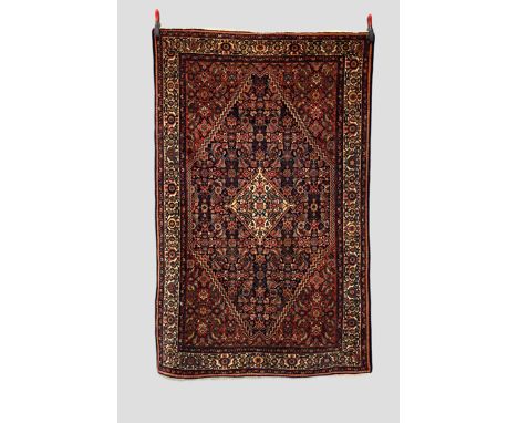 Feraghan rug, north west Persia, circa 1920s-30s, 6ft. 7in. X 4ft. 2in.  2.01m. x 1.27m. Dark blue diamond shape field with i