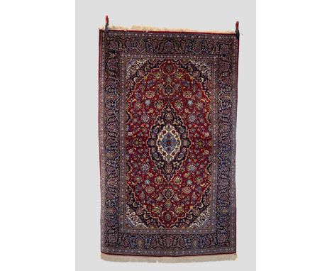 Kashan rug, west Persia, mid-20th century, 7ft. 3in. X 4ft. 6in. 2.21m. X 1.37m.  Dark blue, ivory and light blue central med