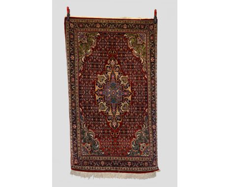 Saruk rug, north west Persia, circa 1940s-50s, 6ft. 2in. X 3ft. 8in. 1.88m. X 1.12m. Light red field with central medallion a