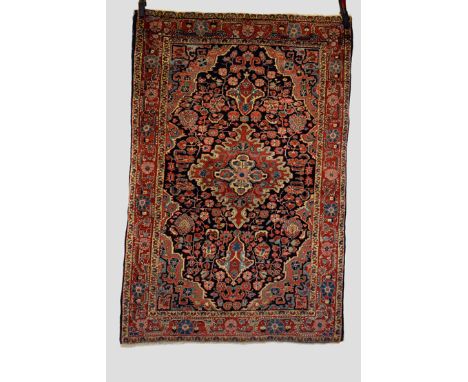 Jozan rug, north west Persia, circa 1930-40s, 5ft. 2in. X 3ft. 5in. 1.58m. X 1.04m. Slight loss to ends. Dark blue field with