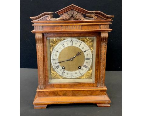 A Lenzkirch Walnut cased Black Forest mantel clock, carved architectural pediment, the brass and silver metal dial with Roman