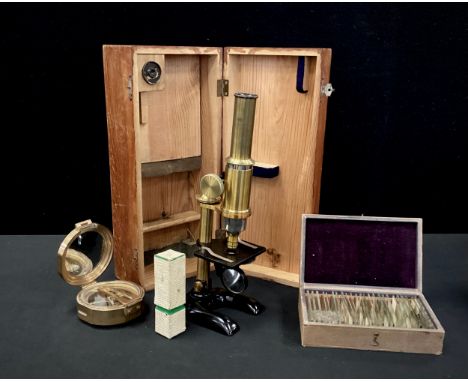 An early 20th century monocular microscope, with pine case;  a box of approximately 25 prepared slides;  Stanley of London na