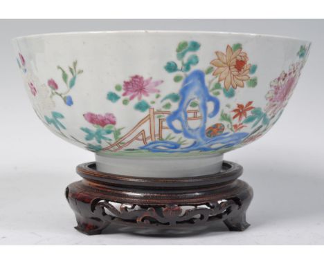 An 18th Century Chinese antique porcelain punch bowl of circular form having hand painted enamel decoration depicting floral 