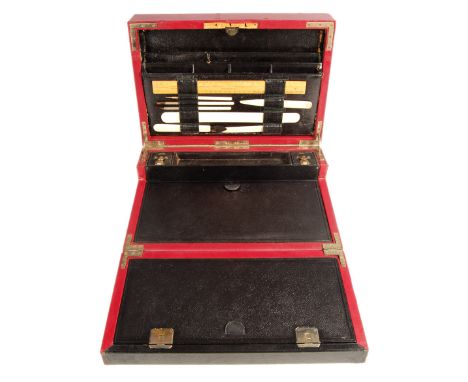 An early 20th century purple leather writing slope box. Inset fold over slope with hinged top opening to reveal sectional inn