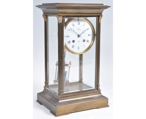 An early 20th Century French large bronze / brass cased mantel clock by Rapport of France having a white enamel dial with Rom