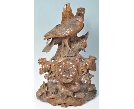 A stunning fine quality 19th Century antique German Black Forest hand carved mantel table clock. Carved depicting a guarding 