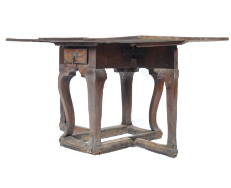 A rare 16th / 17th Century oak gateleg dining table having a rectangular table top with two square drop flap leaves to either