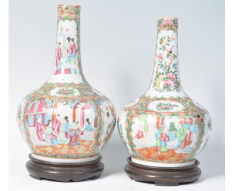 A near pair of 19th Century Chinese Cantonese Canton bottle / onion shaped vases having hand painted enamel decoration depict