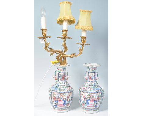 A pair of early 19th Century Chinese export vases having hand painted decoration depicting court scenes with famille rose det