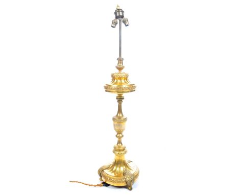 A late 19th / early 20th Century gilded brass ormolu library reading table lamp having raised on reeded base with urn column.