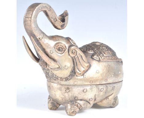 An early 20th century Cambodian Khmer silver white metal betel box in the form of an elephant trumpeting decorated throughout