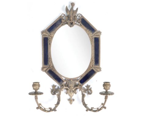 A late 19th / early 20th Century antique wall mirror of brass construction having a central bevelled glass mirror panel set w