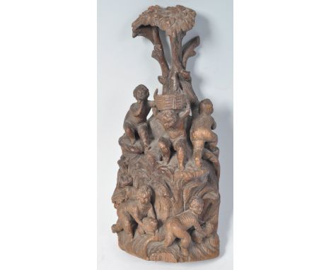 An early 18th Century hand carved wooden figurine group depicting five cherubs in tree. Two to the lower half playing with sq