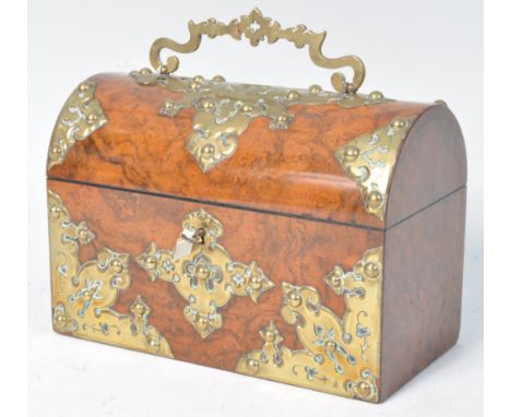 A stunning 19th Century antique walnut dome top tea caddy having large brass Gothic Revival embellishments with swing handle 