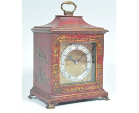 An early 20th Century French Chinoiserie 18th Century manner bracket mantel table clock of small proportions having a red lac