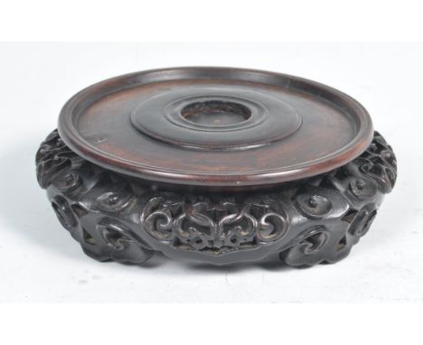 A 19th Century Chinese antique carved hardwood revolving vase stand of circular form comprising of a ' Lazy Susan ' type spin