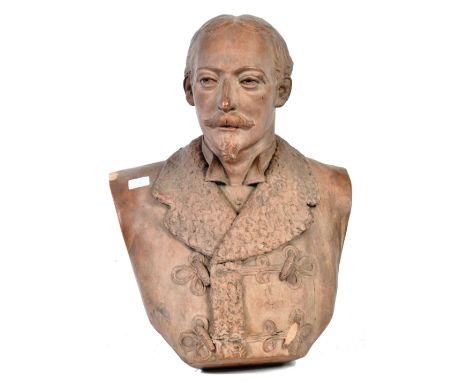 A 19th Century antique terracotta portrait bust depicting a gentleman in heavy woolen lined coat with toggle buttons. The gen