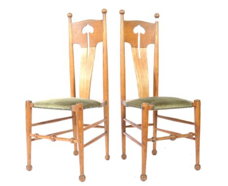 A stunning pair late 19th / early 20th Century William Birch arts and crafts oak dining / side chairs having pierced club arr