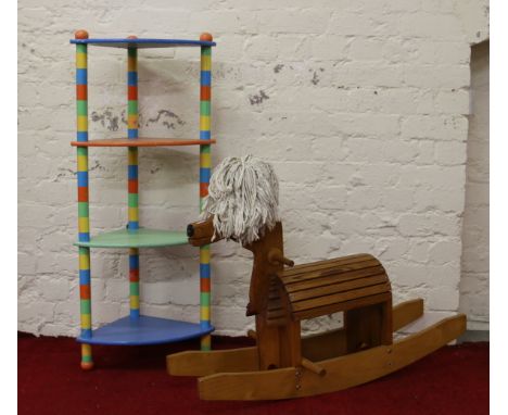 A childs rocking horse along with a multi coloured corner whatnot stand.