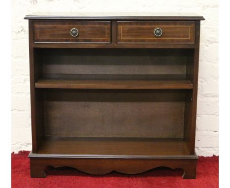 An inlaid mahogany two drawer bookcase raised on bracket feet.