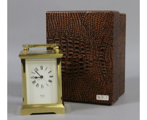A brass cased carriage clock with enamel face by Huber of London.