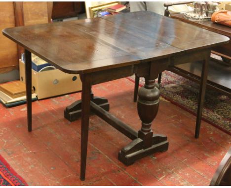 An oak bulbous leg dropleaf dining table.