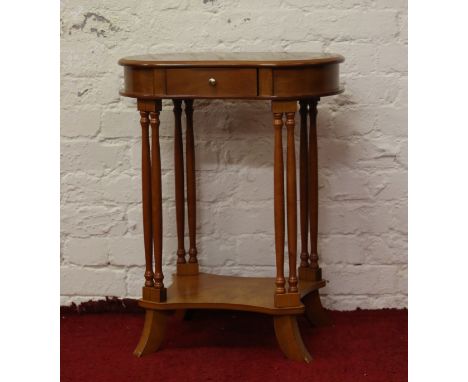 A kidney shaped single drawer side table raised on turned column supports.