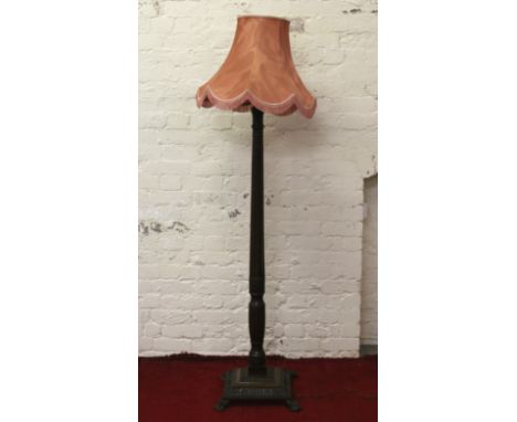 A good quality carved mahogany column standard lamp raised on paw feet.