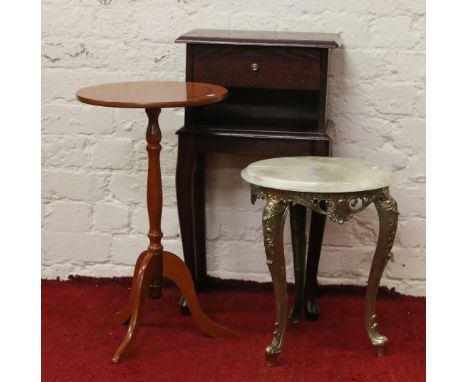 A wooden single drawer bedside cabinet raised on cabriole supports along with a brass based circular marble topped occasional