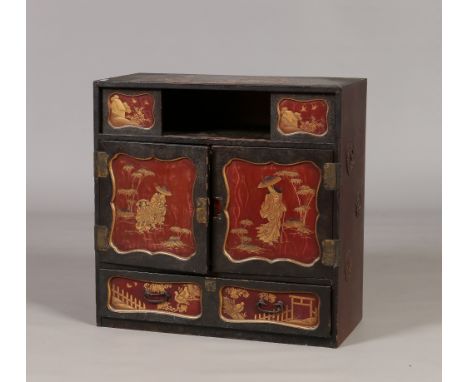 An early twentieth century Japanese lacquered table cabinet. The top section with sliding doors is raised over a central cupb