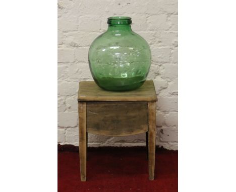 A walnut commode along with a green glass buoy.
