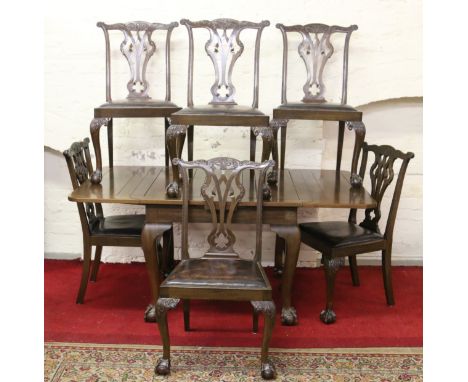 A mahogany drawleaf dining table along with a set of six Chippendale style carved mahogany dining chairs all raised on cabrio