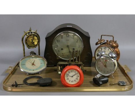 An oak cased mantel clock along with various alarm clocks and movements.
