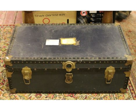 A metal bound storage trunk and contents of two stoneware pots, folding wool basket and a shaped walnut framed mirror.