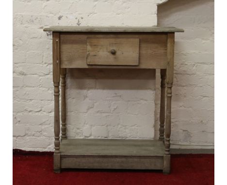 An antique pine single drawer side table raised on turned supports.