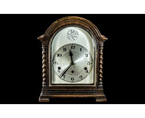 An Early 20th Century Oak Cased Mantle Clock, silvered dial with Arabic numerals, striking on five bells. Oak case with barle
