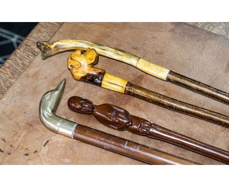 Four Vintage Walking Sticks, comprising sticks with decorative handles including a British Bulldog, an African tribal fertili
