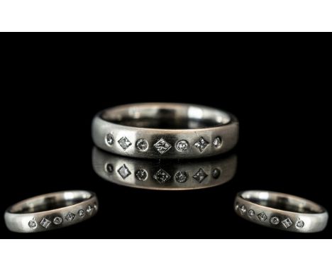 A Platinum Diamond Set Wedding/Eternity Ring,  set with  seven alternating round brilliant cut and princess cut diamonds, ful