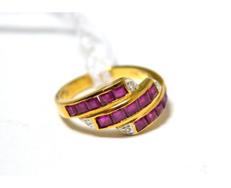 A ruby and diamond three row ring stamped '750'
