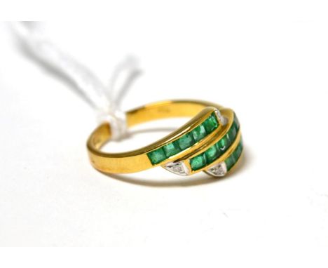 An emerald and diamond three row ring stamped '750'