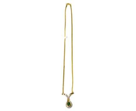 An emerald and diamond necklace, a pear cut emerald claw set within a round brilliant cut diamond pavé set surround, to a yel