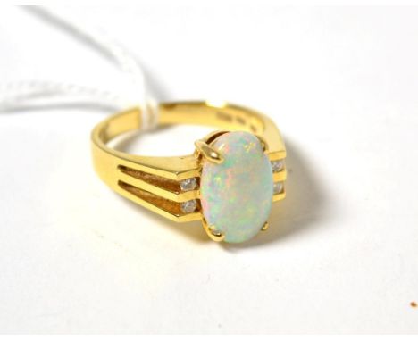 An opal and diamond ring, an oval cabochon opal in a yellow four claw setting, between four round brilliant cut diamonds in c