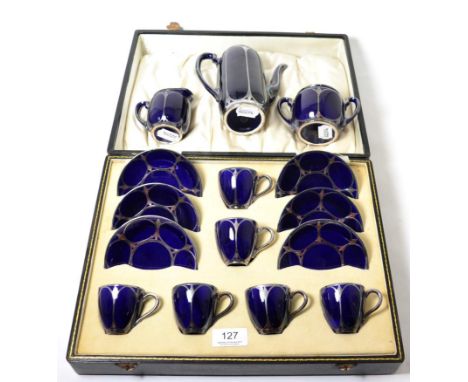 An American Lenox porcelain silver overlaid coffee service, comprising a cased set of six coffee cans and saucers, coffee pot