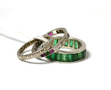 An emerald eternity ring, a diamond eternity ring and a diamond and ruby eternity ring (3) all with losses and/or damageOne e