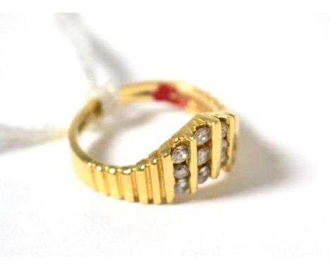 A diamond wishbone ring, with four columns of round brilliant cut diamonds in yellow channel settings, to fluted shoulders on