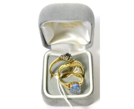 A 9ct gold blue topaz ring, a sapphire cluster ring and a diamond ring (3) 