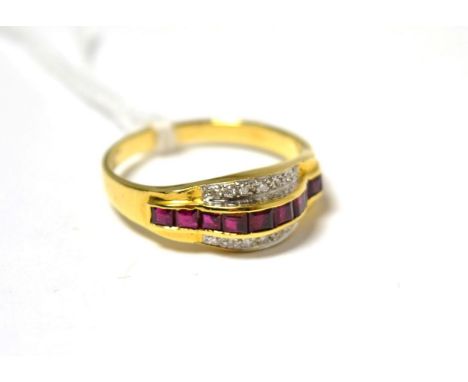 A ruby and diamond ring, calibré cut rubies in yellow channel settings, within a border of round brilliant cut diamonds in wh