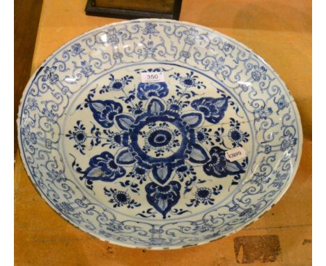 A Chinese porcelain saucer dish, Kangxi, painted in underglaze blue with foliage within a leaf scroll border, 40cm diameter (