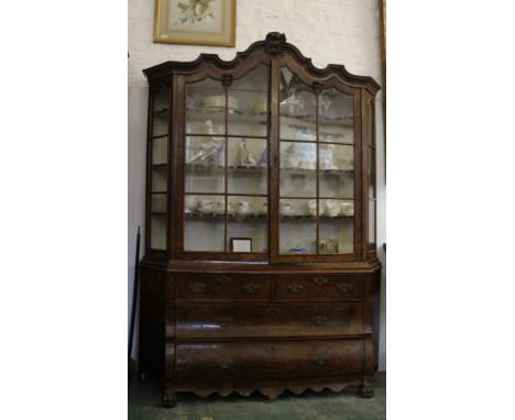 A Dutch burr walnut Delftware or china cabinet, the moulded cornice with rococo shell detail, a pair of glazed doors and side