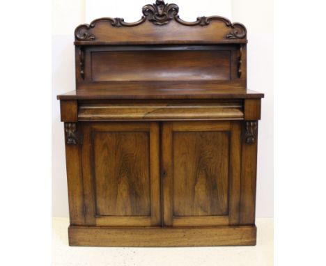 A rosewood Victorian chiffoniere, c1850, single frieze drawer, high back with shelf and foliate carved pediment, 104 x 140 x 